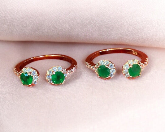 Three emerald rings on a white background
